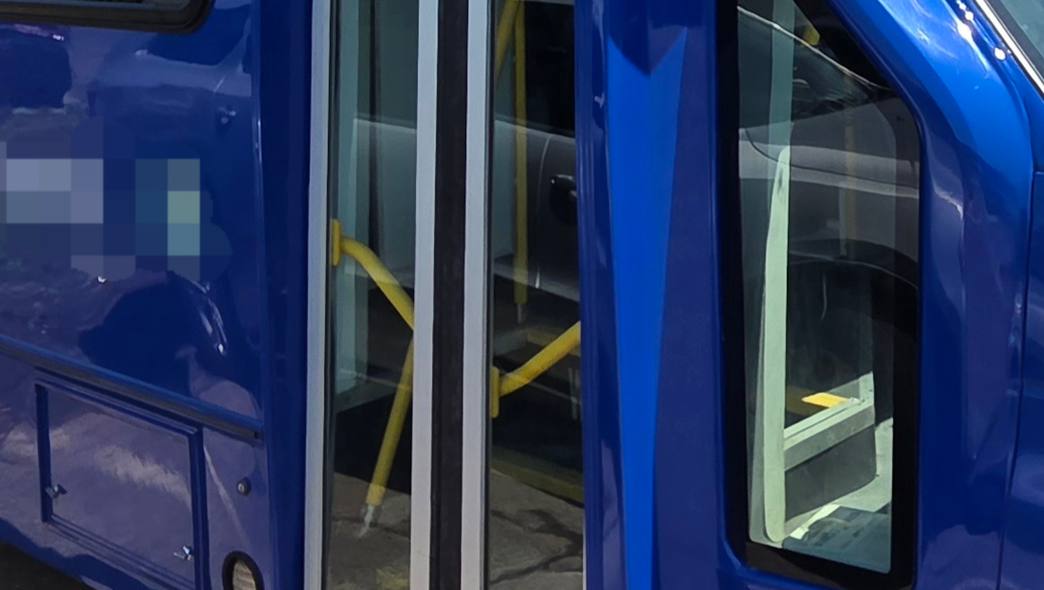 Blue paratransit bus with the entry door repaired and repainted at Mickey's Auto Body, serving Newark, NJ