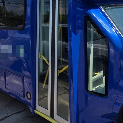 Blue paratransit bus with the entry door repaired and repainted, Kearny NJ