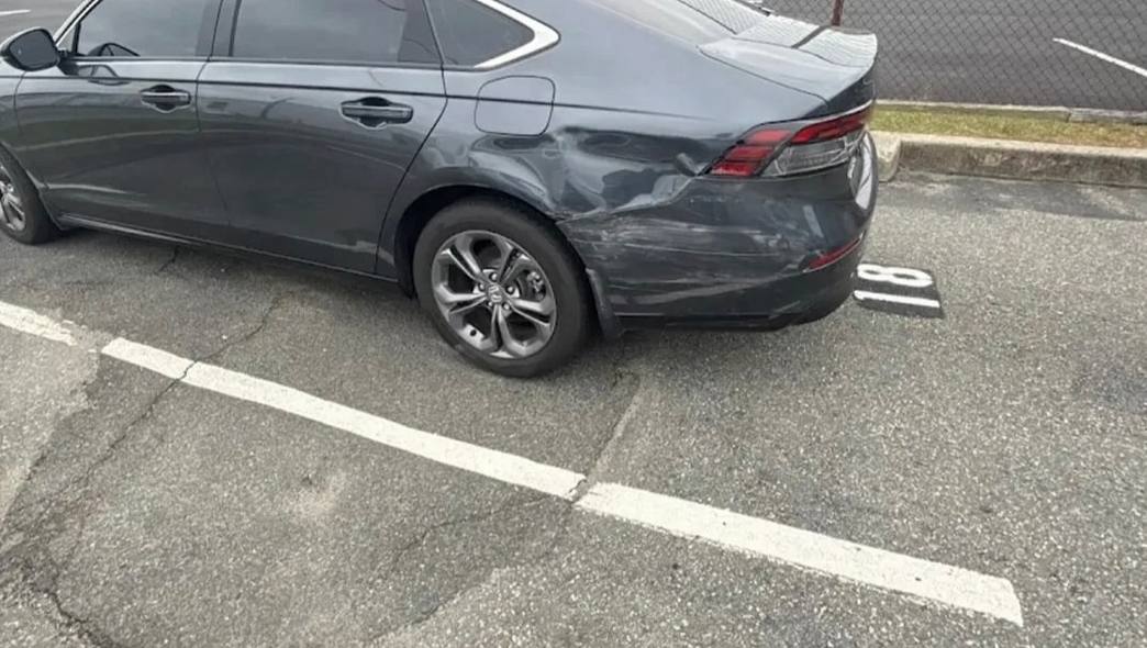 Dented rear quarter panel on a gray Honda Accord before dent removal at Mickey's Auto Body in Kearny, NJ