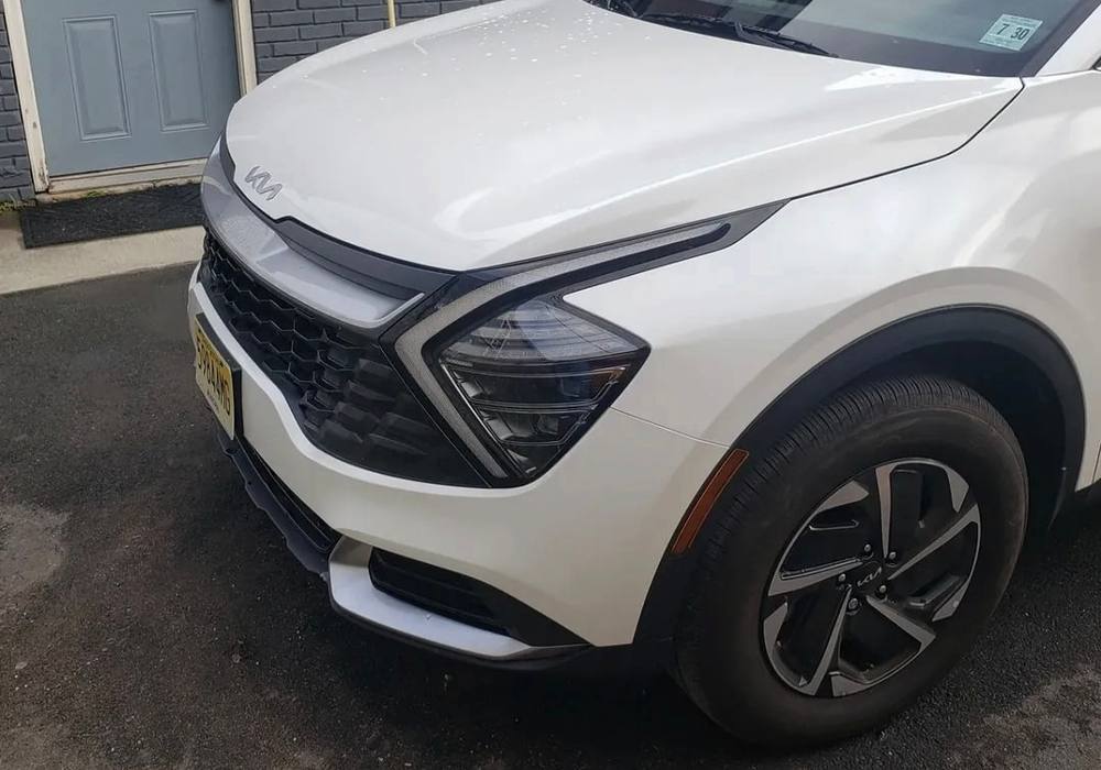 White Kia Sportage with the front end rebuilt and repainted at Mickey's Auto Body, the collision repair shop serving Belleville, NJ