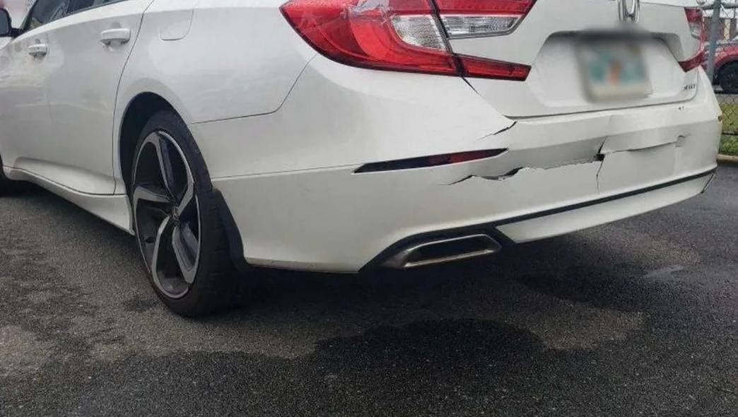 Torn rear bumper on a white Honda Accord before bumper repair at Mickey's Auto Body in Kearny, NJ