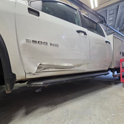 Before: driver's-side collision damage on a white Chevrolet 3500HD work truck, Kearny NJ