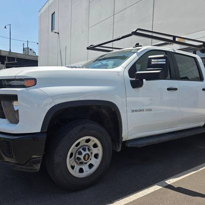 After: the same white Chevrolet Silverado 3500HD restored to factory finish