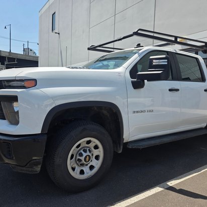After: the same white Chevrolet Silverado 3500HD restored to factory finish