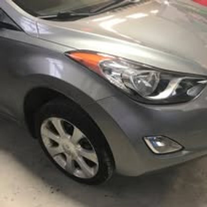 After: the same silver Hyundai Elantra with the front end repaired and repainted