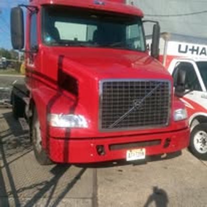 After: the same red Volvo semi tractor repaired and repainted in Kearny, NJ
