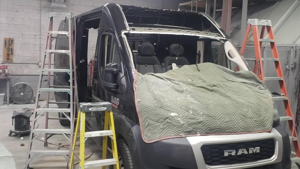 Dark navy Ram ProMaster van with the roof removed for structural repair at Mickey's Auto Body in Kearny, NJ