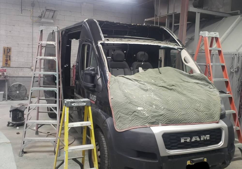 Dark navy Ram ProMaster van with the roof removed for structural repair at Mickey's Auto Body in Kearny, NJ