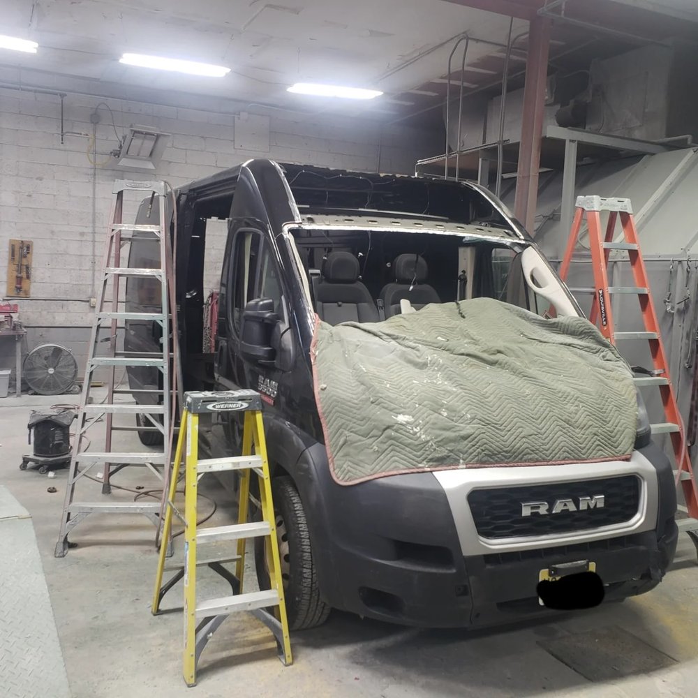 Dark navy Ram ProMaster van with the roof removed for structural repair at Mickey's Auto Body in Kearny, NJ