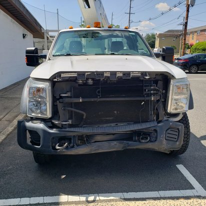Ford utility truck with the front end disassembled for collision repair, Kearny NJ