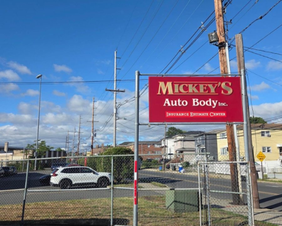 Mickey's Auto Body sign above the shop lot on Schuyler Avenue in Kearny, NJ